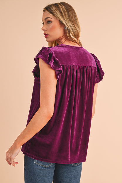 Blouse violette à manches courtes et volants à col noué