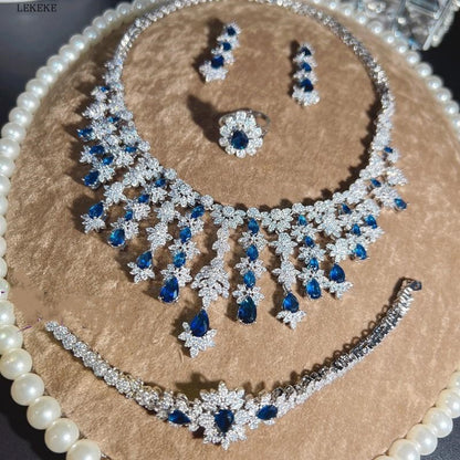 Conjunto de cuatro piezas de pulsera, pendientes y collar con borlas de circón y diamantes de imitación azul