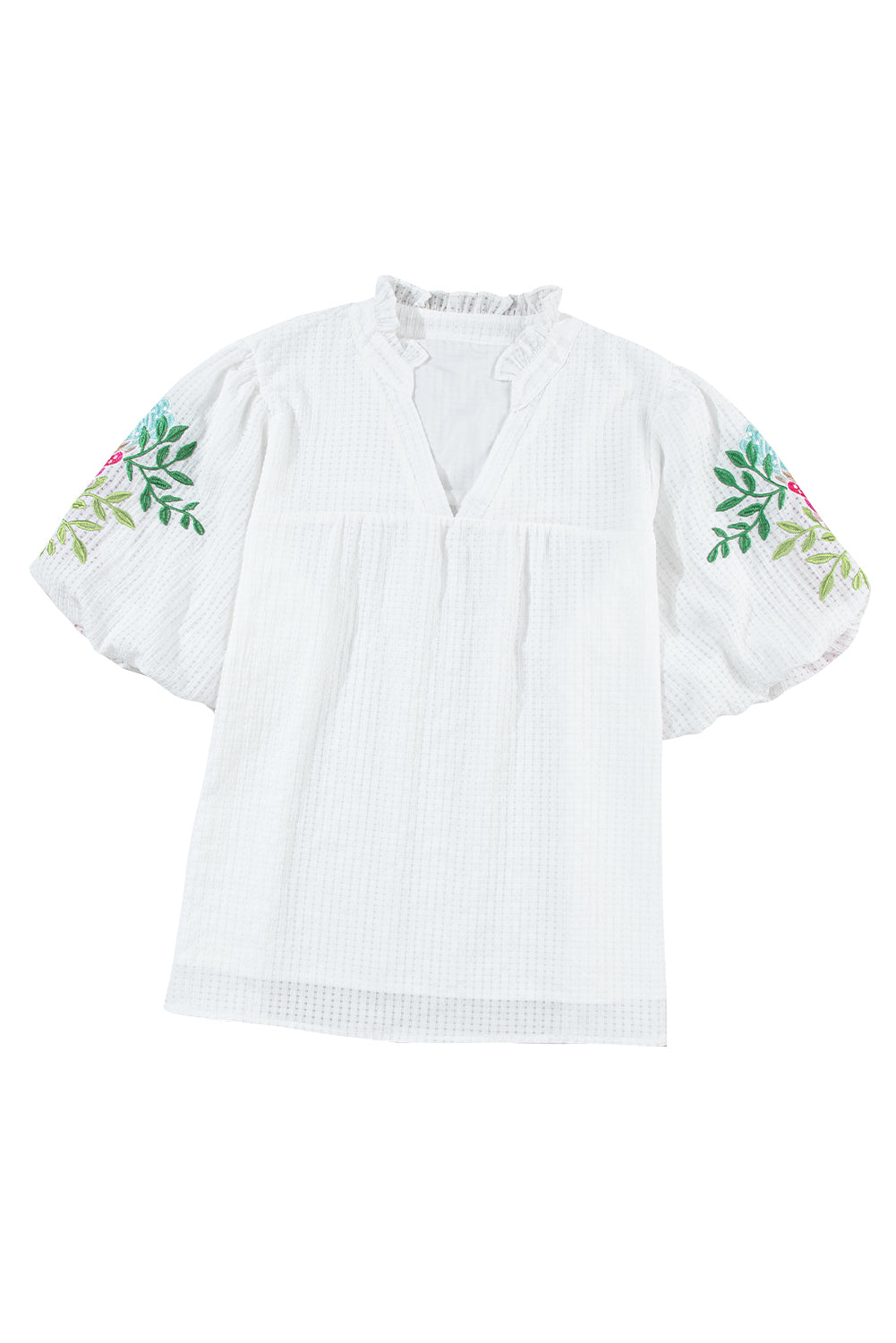 Blouse blanche à col cranté et manches bouffantes brodées de fleurs