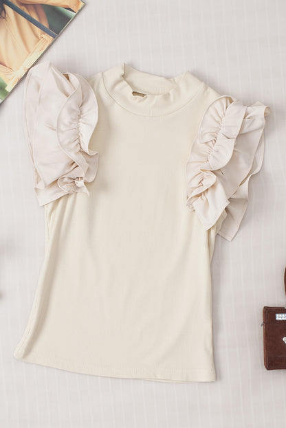 Blouse côtelée beige à volants et manches flottantes à col haut